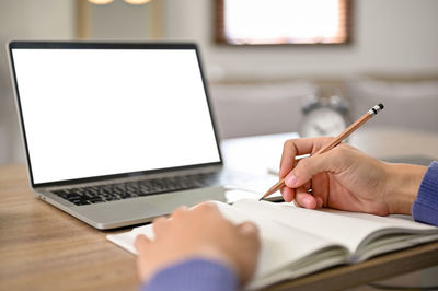 Midsection of man using digital tablet at office