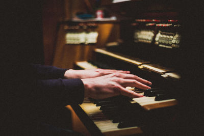Close-up of man playing piano