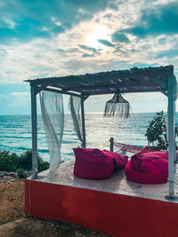 Chairs on beach against sky