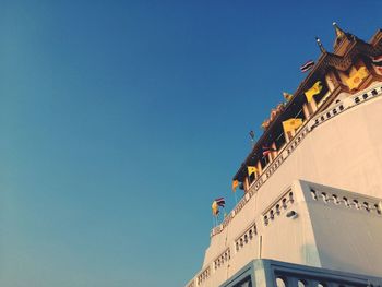 Low angle view of building against clear blue sky