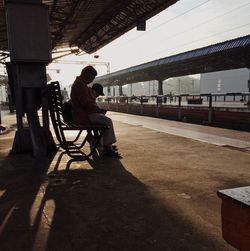 Rear view of woman sitting on seat in train