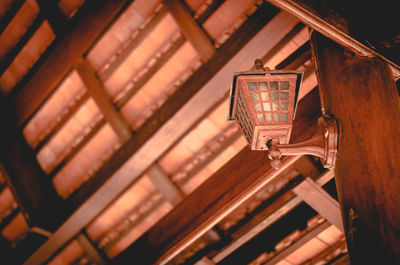 Low angle view of illuminated lanterns hanging on ceiling of building