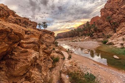 Scenic view of cliff against sky during sunset