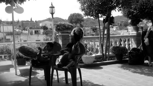 Rear view of woman sitting on bench