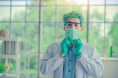Portrait of young scientist wearing mask at laboratory