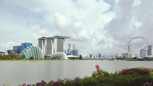 View of city buildings against cloudy sky