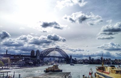 View of bridge over river against cloudy sky