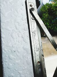 High angle view of raindrops on metal railing