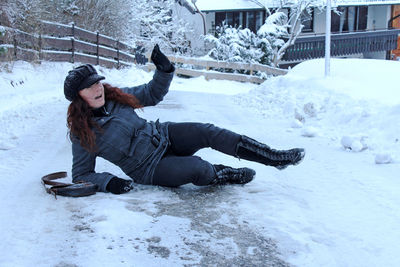 Full length of young woman on snow covered field