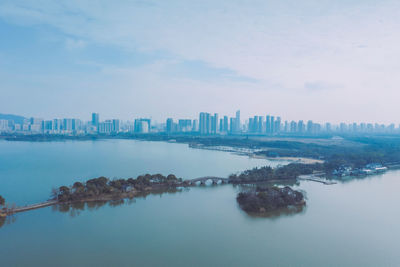 Scenic view of sea and buildings against sky