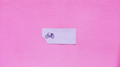 Sign on pink wall