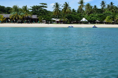 Scenic view of swimming pool by sea against sky