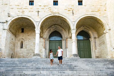 Low angle view of heterosexual couple standing on stairs