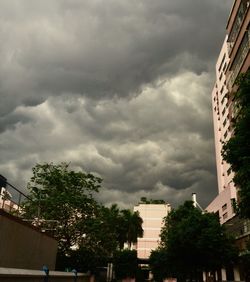 Low angle view of buildings against cloudy sky