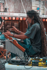 Side view of woman playing music concert