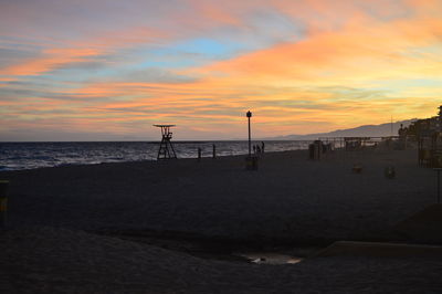 Scenic view of beach against sky during sunset