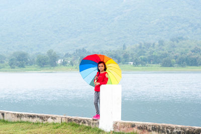 Woman standing in lake during rain