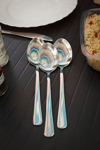 Multi-colour reflection in dessert spoons. 