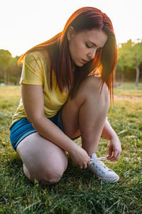 Young woman sitting on field