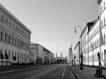 Street amidst buildings against clear sky