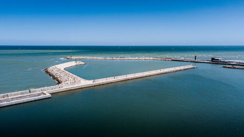 Scenic view of sea against clear blue sky