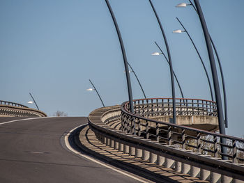 Footbridge against clear blue sky