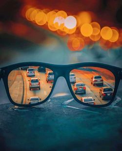 Close-up of sunglasses on illuminated street