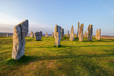 Panoramic shot of rocks on field against sky