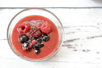 Close-up of smoothie with fruits in glass on table