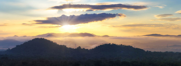 Scenic view of silhouette mountains against sky at sunset