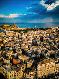 High angle view of townscape by sea against sky