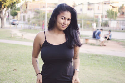 Portrait of smiling young woman standing outdoors