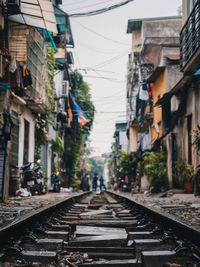 Railroad tracks amidst buildings in city