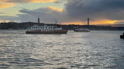 Ship sailing on sea against sky during sunset