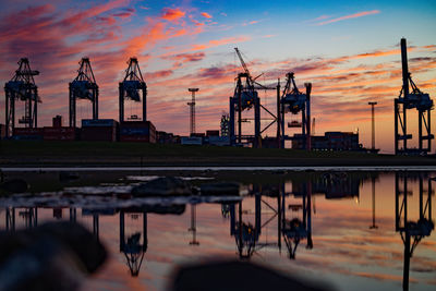 View of pier at harbor against sky during sunset