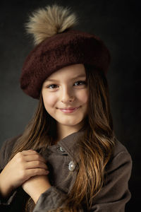 Portrait of beautiful young woman in hat