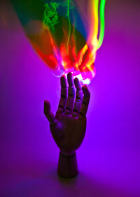 Close-up of illuminated light bulb on table