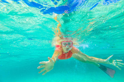 Close-up of young woman swimming in sea