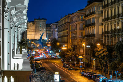 Illuminated city street and buildings at night