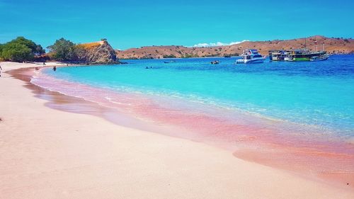 Scenic view of beach against blue sky