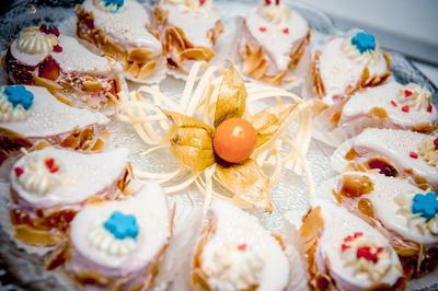 Close-up of cupcakes and winter cherry in plate