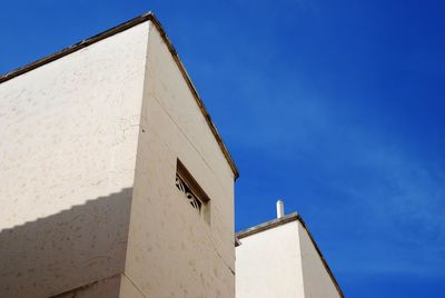 Low angle view of building against blue sky