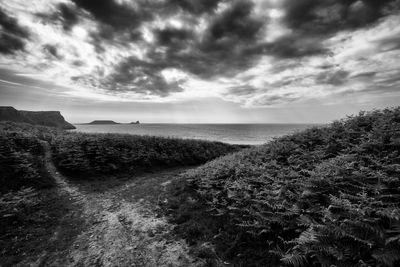 View of beach against cloudy sky