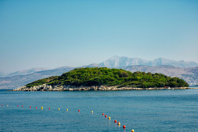 Scenic view of sea against clear blue sky