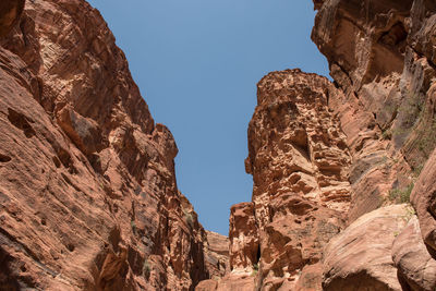 Low angle view of rocky mountains against sky