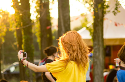 Rear view of woman photographing