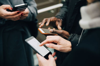 Midsection of woman using mobile phone