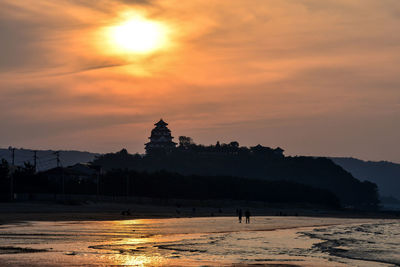 Silhouette of building during sunset