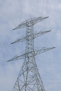 Low angle view of electricity pylon against sky