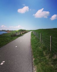 View of road in countryside against sky